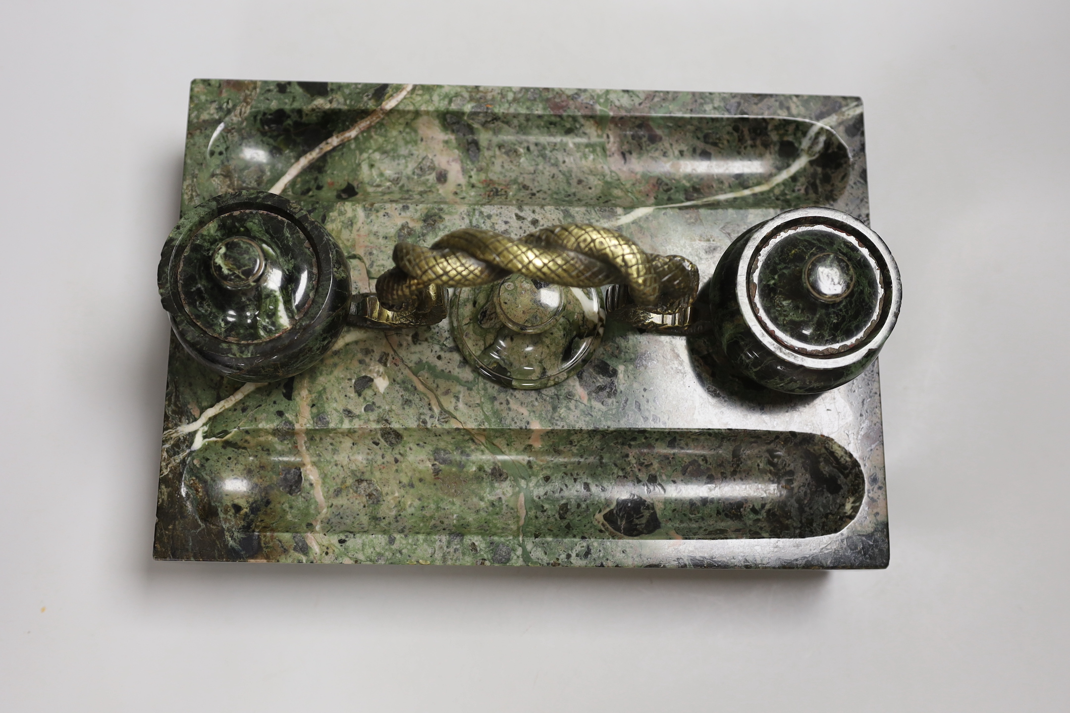 A 19th century green marble inkstand, with brass snake handle, 33cm wide, 23cm deep